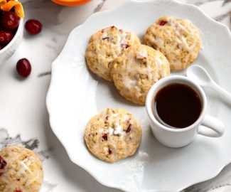 Plate of citrus cranberry cookies with lemon drizzle