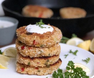 stack of four vegan crab cakes with tartar sauce on top